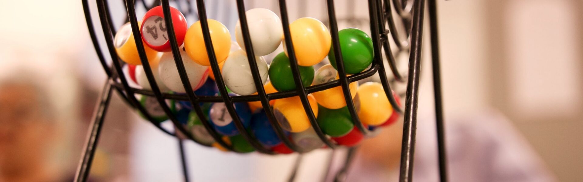 rotary bingo cage with colorful numbered balls inside